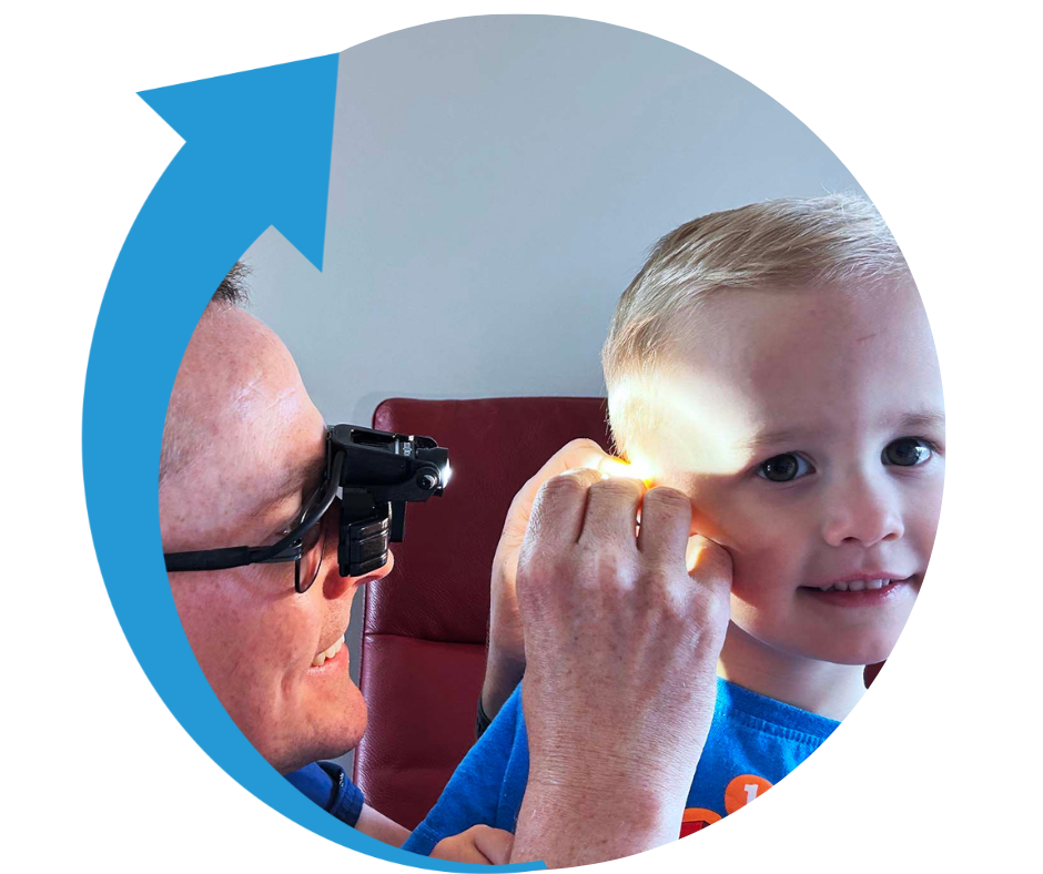 Dan Anderson ENT Surgeon checking young boy's ear